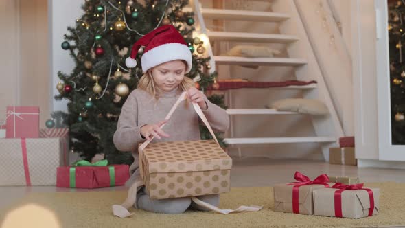 Little Girl Opening Christmas Present alt