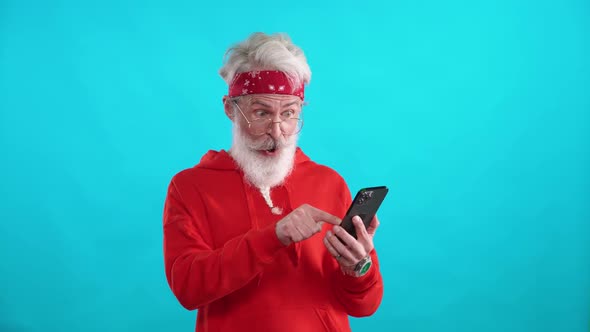 Adult Grayhaired Man in a Red Hoodie Finds Good Products and Useful Information Online Using a alt