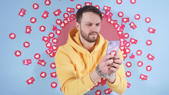Male Blogger Uses a Smartphone to Blog on the Internet alt