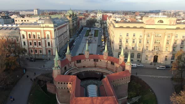 Flying over Barbican (Barbakan) towards Matejko Square, Krakow, Poland alt