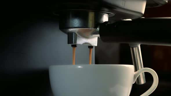 Pouring Coffee Stream From Machine in Cup alt