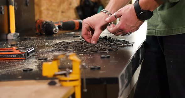 Man hands take in handful self-tapping screws
