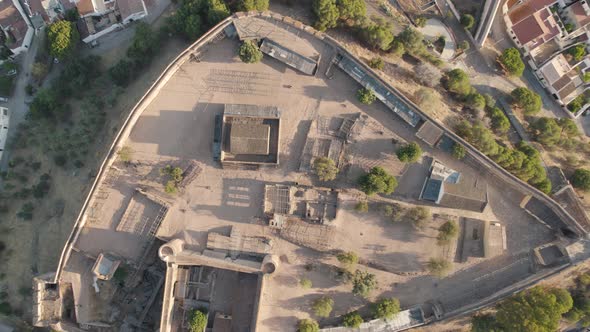 Directly above ascending view of Castro Marim medieval castle on hilltop overlooking the town alt