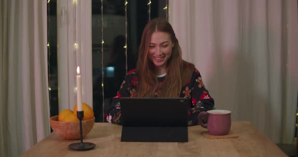 Young Female at Xmas Using Tablet Video Call