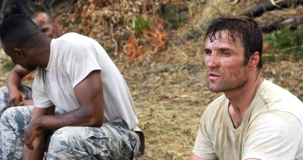 Fit men interacting with each other during fitness training exercise alt