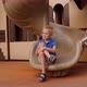A Small Boy is Sitting on a Slide on the Playground in the Courtyard - VideoHive Item for Sale