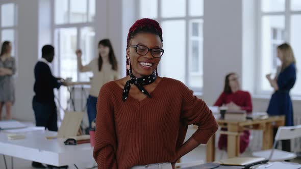 Portrait of Young Happy African Design Professional, Cheerful Business Woman in Eyeglasses Smiling alt