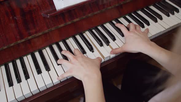 Musician Plays the Chords on Piano with Hands View From Above alt
