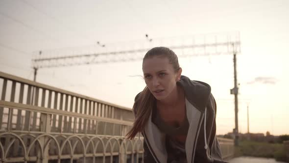 Slomo Pretty Athletic Girl Taking a Break From Running Standing with Hands on Her Knees and Looking alt