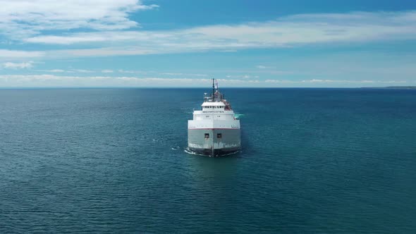 Aerial view straight on of lake freighter on Superior near Duluth, Minnesota - ascending drone shot alt