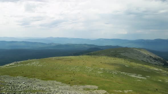 Panorama of green hill and mountains alt