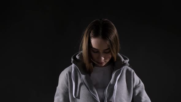 Determined woman zips up hoodie to go running in cold weather alt