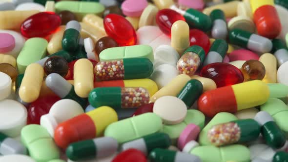 Close Up of Different Colored Medical Pills and Drugs Rotate in Circle