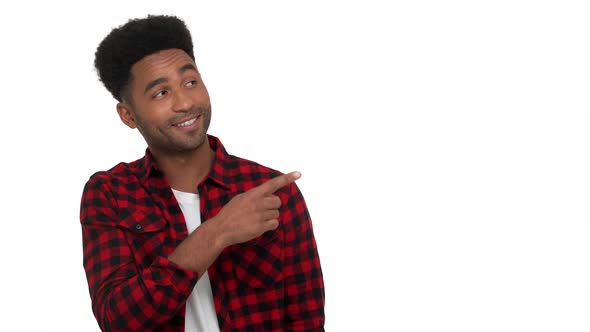 Portrait of Cheerful Darkskinned Man with Cool Hairstyle Pointing Finger Waving Hand with Doubt alt