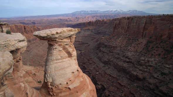 Panning view of desert canyon near Moab Utah from cliffs edge alt