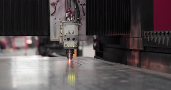 Process Of Laser Cutter Cutting Flat Metal Sheet In A Factory