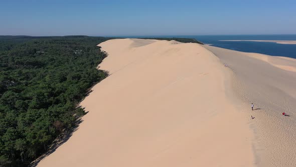 Overview of Dune du Pilat Sandhill in Arcachon Bassin France with People walking along the top ridge alt