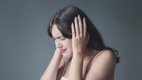 Young Brunette Woman Closing Ears Eyes Suffering From Loud Noise or Sound Hurt alt