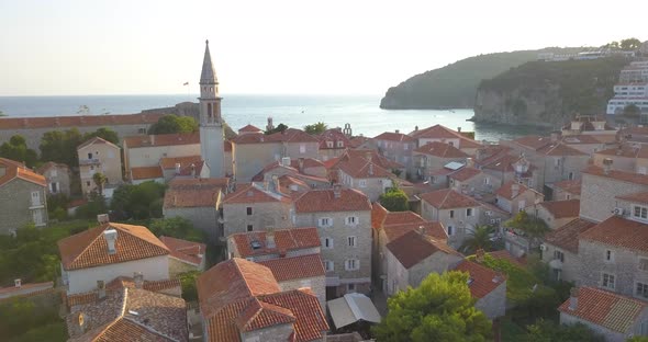 Awsome Aerial Footage of Old Town Budva, Montenegro. Drone Flies Over the Old Roofs Towards the Sea