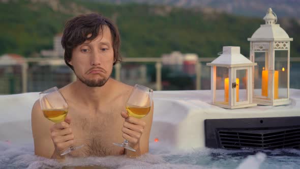 Sad Man with Wine Glasses is Sitting in a Hot Tub alt
