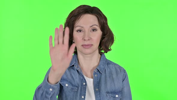 Stop Gesture By Old Woman on Green Chroma Key Background  alt