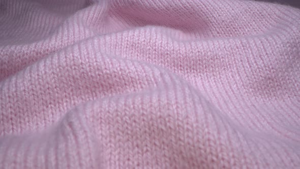 Cozy sheep wool pink fabric texture in macro. Handcraft knitting woolen sweater alt