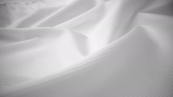 Shiny flowing cloth texture dolly shot in close up view macro shot. alt