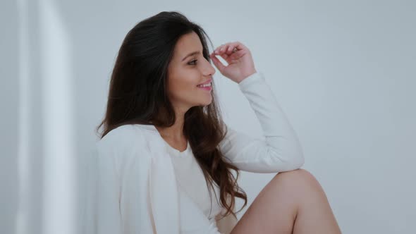 Smiling Girl Model Posing for the Camera Model Posing in a White Studio for a Photo