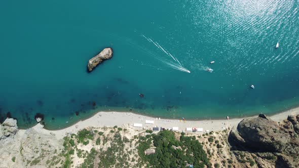 Aerial View From Above on Calm Azure Sea and Volcanic Rocky Shores alt