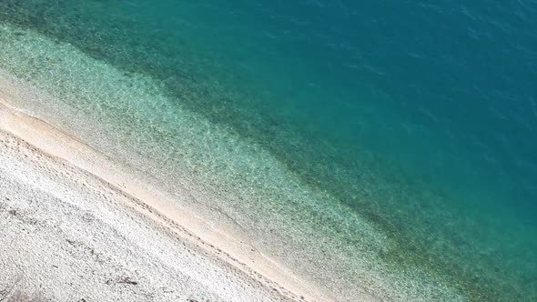 Pebble Beach And Clear Blue Sea Aerial View