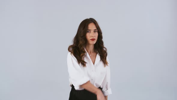 Woman Director in White Shirt is Holding White Paper Sheets and Throwing Them Up alt