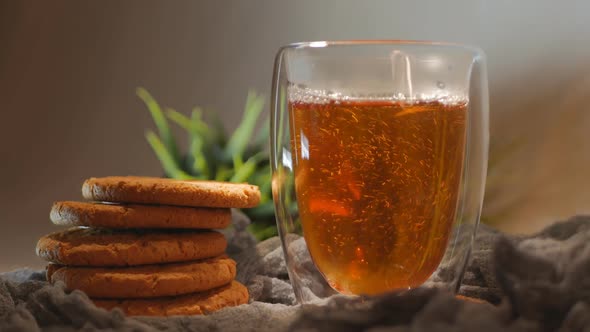 Pouring Hot Tea Into Double Glass Glass alt
