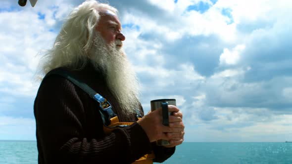 Fisherman drinking cup of coffee alt