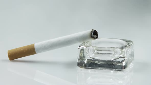 Ashtray with a lit cigarette alt