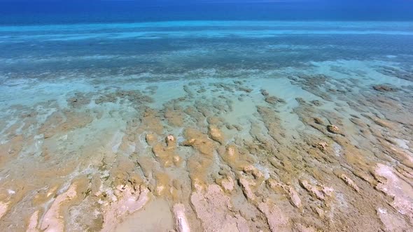 White Sandy Coral Reef in the Clear Turquoise Light Blue Sea of the Tropical Coastline alt