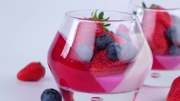 Fruit Jelly with Strawberries and Blueberries in a Glass on a White Background a Beautiful Dessert