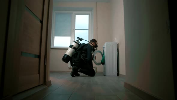 Man puts on a diver suit to check his broken washing machine