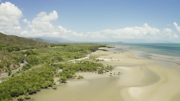 Aerial, Low Tide And Huge Sand Ocean Bed And Mangroves Growing In Queensland Australia