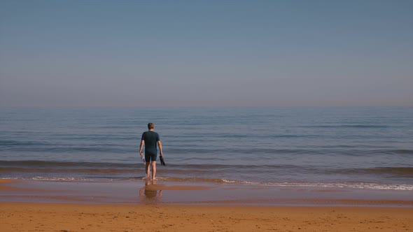 Man In Wetsuit And Sea alt