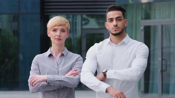 Multiracial Couple of Business Colleagues Serious Coworkers Caucasian Mature Woman with Short Hair alt