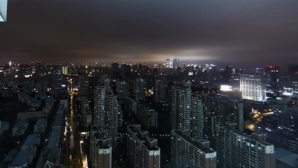 Aerial timelapse over the Pudong district of Shanghai with low and fast moving clouds alt