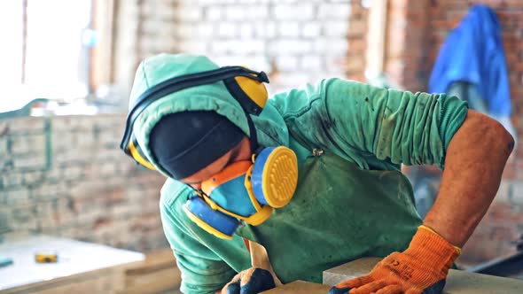 Large granite blocks. Worker at process with granite blocks alt