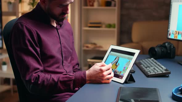 Side View Photographer Doing Retouching on Tablet Computer alt