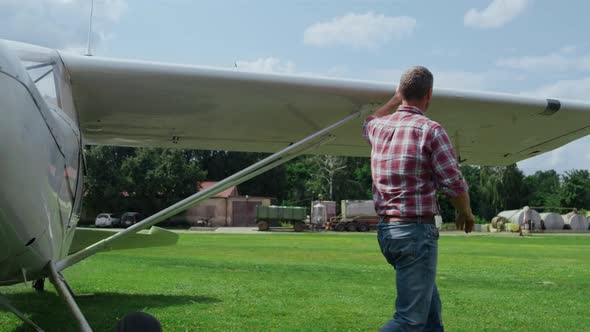 Aviator Checking Small Plane Before Flying Countryside Aerodrome Runway alt
