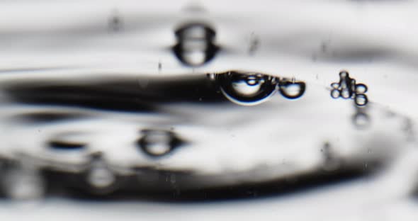 Bubbles On A Moving Surface Of Water Against White Background alt
