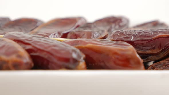 Phoenix dactylifera exotic fruit  packed on white background  slow panning 4K 2160p UltraHD footage  alt