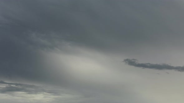 Slow moving time lapse of beautiful evening clouds with muted warm tones. Weather is typical of summ alt
