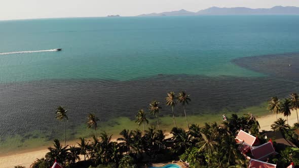 Oriental Houses on Seashore. Drone View of Lovely Oriental Cottages and Green Coconut Palms alt
