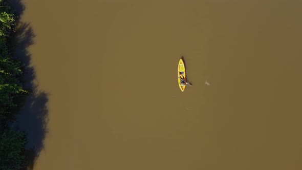Kayaker Rowing Along Tropical River in Pantanal Brazil