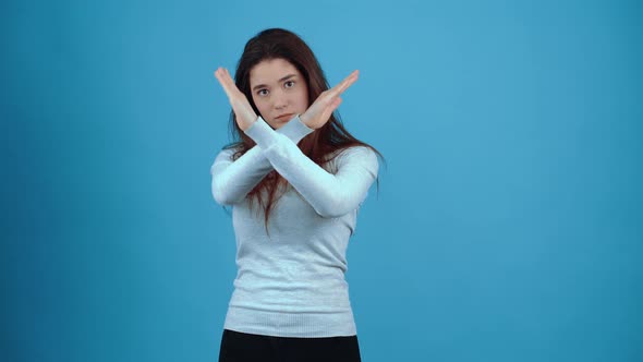 Stop the Young Woman Crosses Her Hands Forward with a Stern Face to Stop alt